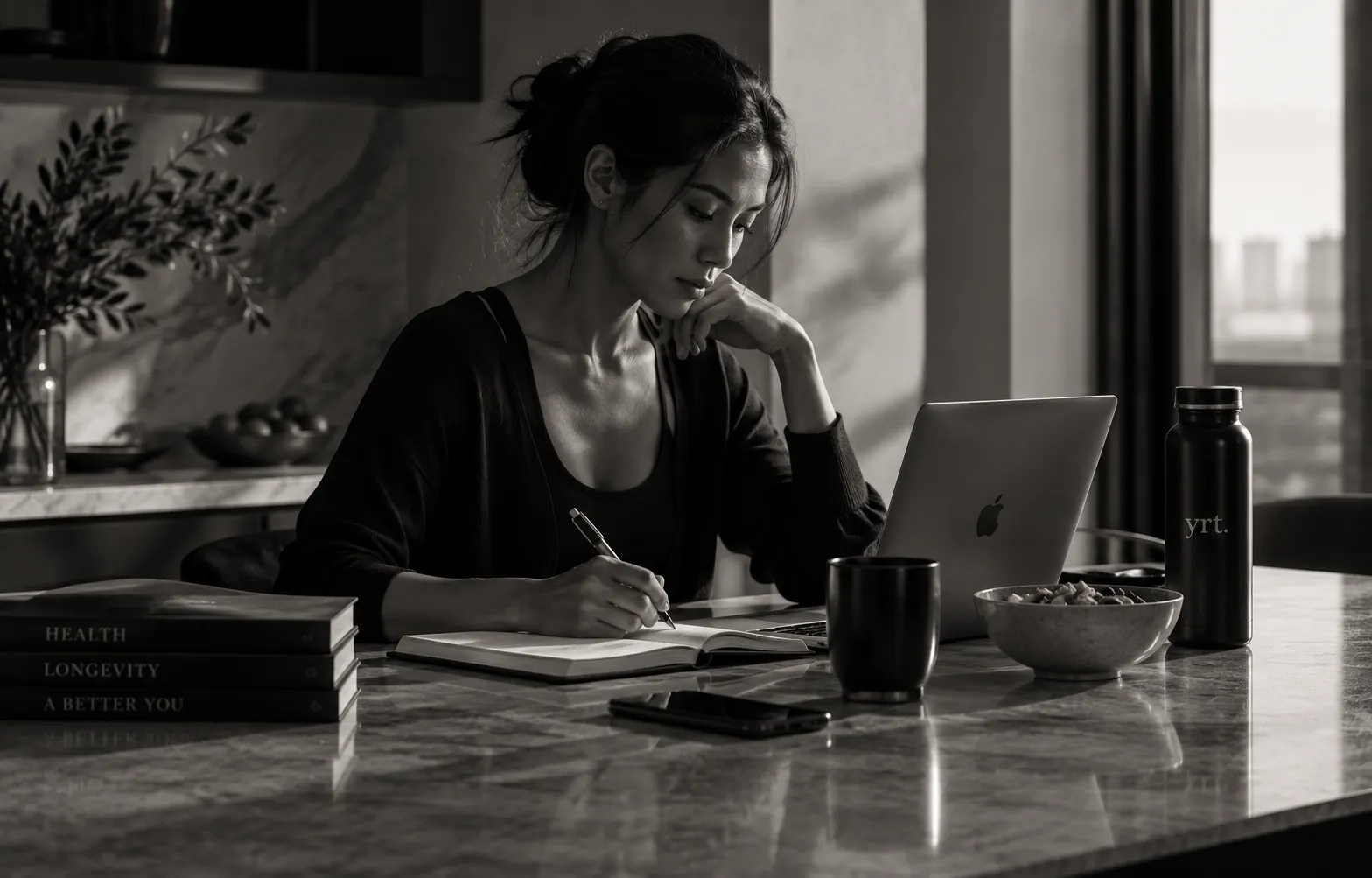 A member journaling at her kitchen counter, researching her own health